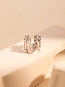 Macro view of silver liquid lava style open ring with metallic dripping texture