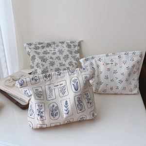 Three minimalist cotton floral makeup bags with zippers featuring simple wish label