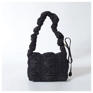 Detail of black puffy cloud bag showing quilted texture and ruched shoulder strap
