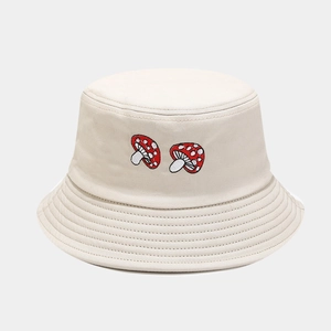 Close-up of mushroom embroidery and stitched brim on beige cotton bucket hat
