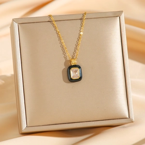 Elegant gold necklace with a black enamel rectangle pendant and a clear zircon gemstone