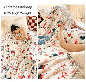 Detail of plush Christmas flannel blanket featuring festive red trucks and snowflakes