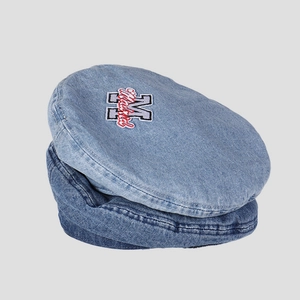 Close-up of letter embroidery on light and dark blue washed denim beret hats