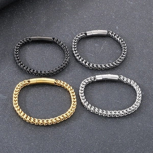 Close-up of vintage dragon bone chain bracelets in black, gold, and silver finishes