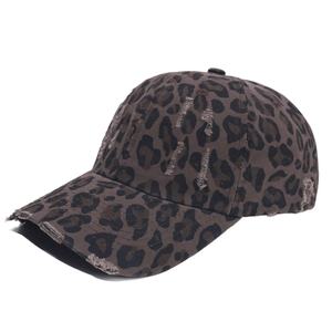 Detail view of leopard print baseball cap with distressed brim and rugged canvas texture
