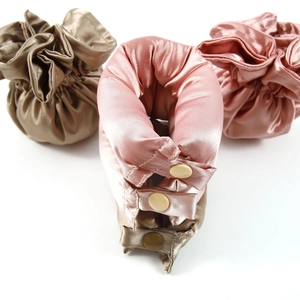 Silk satin heatless hair curler set in bronze and pink colors on white background