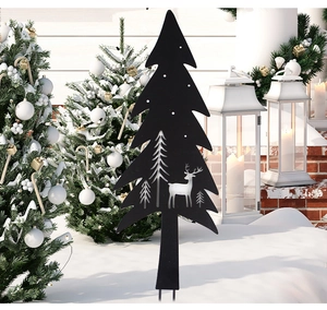 Black metal Christmas tree yard stake with reindeer cutouts standing in winter snow