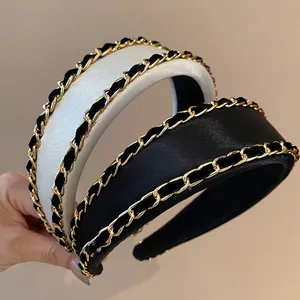 Padded fabric headbands in black and white with golden chain and woven ribbon design
