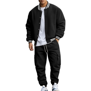 Close-up of black men's baseball jacket and joggers with ribbed striped cuffs and collar