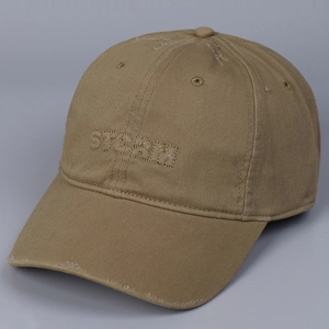 Close-up of distressed cotton baseball cap featuring STORM embroidery and frayed edges