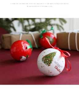 Close-up of a white Christmas ball with Merry Christmas text on a festive background