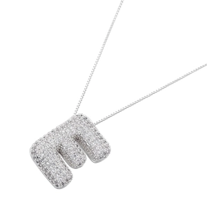 Macro shot of silver-tone bubble letter E pendant with clear zircon micro-paving on box chain