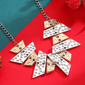 Close-up of geometric Christmas tree earrings with sparkling rhinestones and gold texture