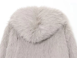 Macro shot of grey faux fur hoodie showing soft texture and premium silver-grey fibers
