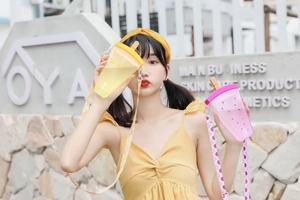 Outdoor shot of creative ice cream shaped plastic water bottles with colorful straps