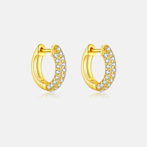 Macro detail of gold-plated silver hoop earrings with triple row pave-set white crystals
