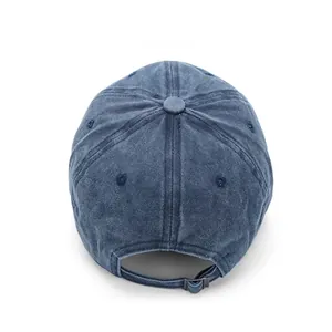 Detail view of the washed denim baseball cap with an adjustable metal buckle on the back