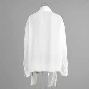 Rear view of white long-sleeved chiffon shirt showing loose silhouette and back details