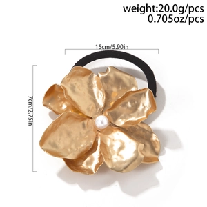 Detailed view of golden flower hair tie with pearl center and precise size measurements