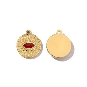 Detail of round gold stainless steel pendant featuring red enamel evil eye design