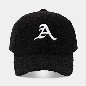 Detailed close-up of premium black sherpa baseball cap with white 3D letter A embroidery