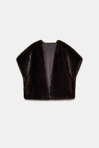 Close-up of soft dark brown faux fur vest texture on light gray background