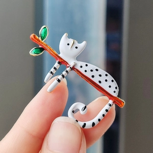 Cute cartoon spotted cat brooch made of alloy enamel climbing on a green leaf branch
