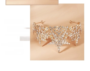 Detail of a luxury bridal star crown featuring golden alloy and sparkling crystals
