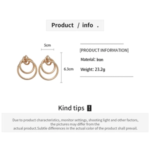 Detail view of triple interlocking golden hoop earrings showing 5cm width and 6.3cm height