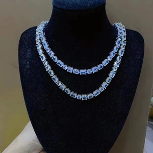 Macro view of double-layer silver cuban chain necklace with micro-pave zircons on a bust