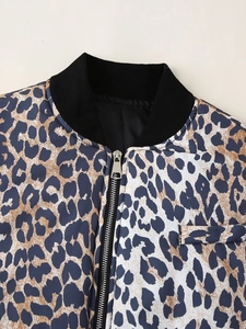 Close-up of leopard print jacket featuring black ribbed collar and silver metal zipper detail