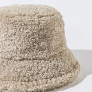 Minimalist beige plush bucket hat for women featuring soft fleece texture and warm design