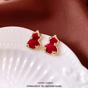Elegant red velvet gourd stud earrings with gold plating and sparkling zircon accents