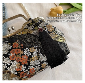 Detailed embroidery of floral patterns on Chinese retro shell handbag with tassel