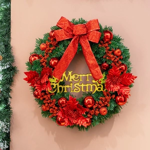 Lush red and gold Christmas wreath with Merry Christmas sign on warm neutral wall
