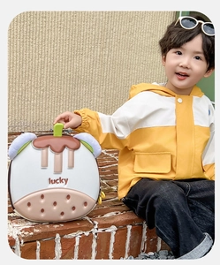 Close-up of cute mangosteen-shaped hardshell kid backpack with lucky text and 3D details