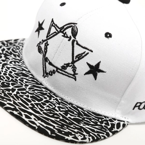 Detailed close-up of stylized star embroidery and unique textured brim on hip hop cap