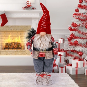 Standing Christmas gnome doll in red hat by fireplace, festive holiday home decoration