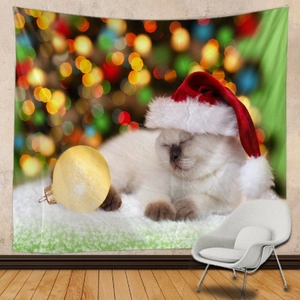 Christmas tapestry featuring a sleeping white kitten in a red hat and gold ornament