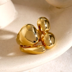 Macro shot of liquid metal style double layer gold ring on matte ceramic texture