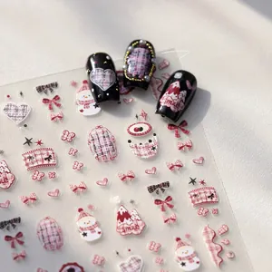 Detail of Christmas nail stickers with red hearts, snowmen, and plaid patterns