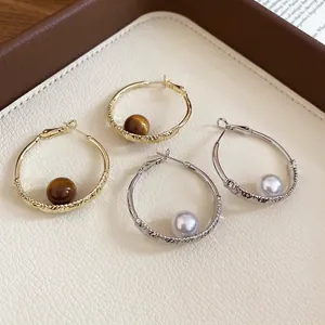 French style pearl and textured metal hoop earrings in gold and silver finishes