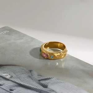 Detail of 18K gold-plated wide band ring with hammer texture and colorful zircon stones