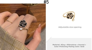 Detail of adjustable gold ring with black rose design, rhinestones and retro oil finish