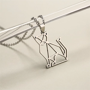 Detailed close-up of a minimalist geometric origami cat pendant on a silver metal chain