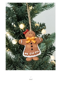 Macro detail of gingerbread man ornament with bow on a festive Christmas tree