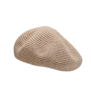 Beige knitted wool beret with wavy ribbed texture for women in a minimalist style