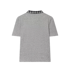 Detail of grey polo shirt back featuring black and grey plaid patchwork collar design