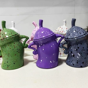 Close-up of attitude canisters with hands-on-hips shape and colorful speckled finish