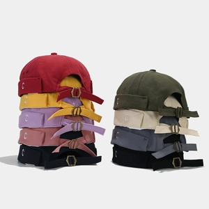 Detail of colorful cotton docker hats with embroidered C letter and adjustable metal buckle